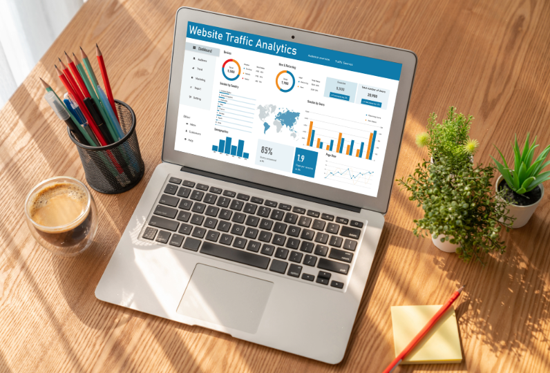 Picture of an open laptop on a desk displaying a webpage for website analytics.